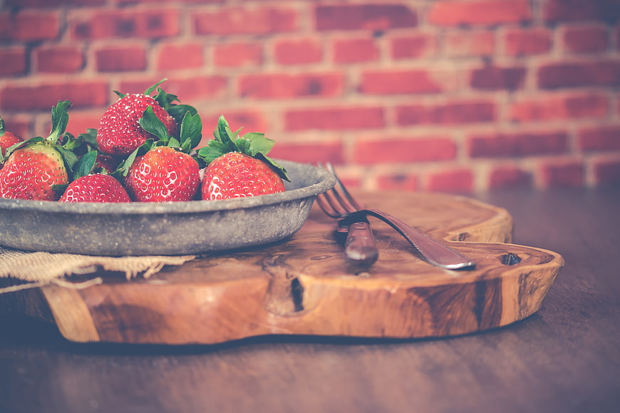 Fresh Strawberries in Bowl on Wooden Board