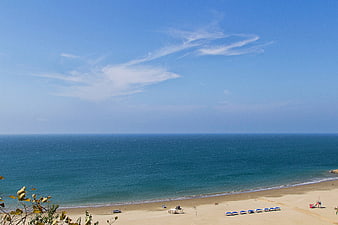 High Angle View of Blue Ocean and Sandy Beach with Umbrellas