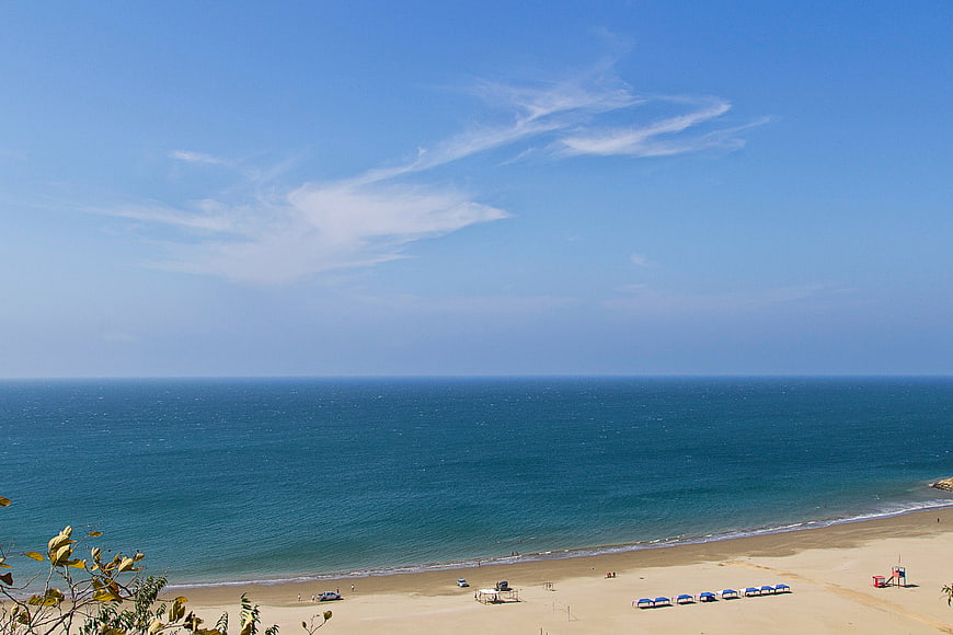 High Angle View of Blue Ocean and Sandy Beach with Umbrellas