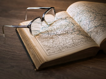 Vintage Glasses on Open Antique Map Book