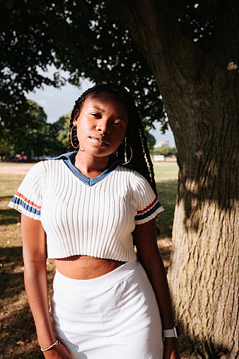 Confident Black Woman Portrait in Park with Tree