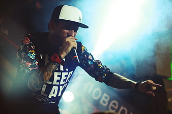 Male Rapper Performing on Stage with Microphone