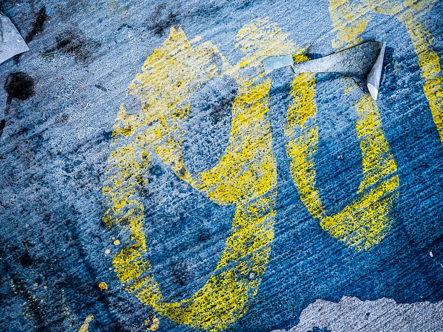 Yellow Graffiti on Blue Concrete Wall Texture