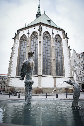 Bronze Bird Fountain in Front of Gothic Church