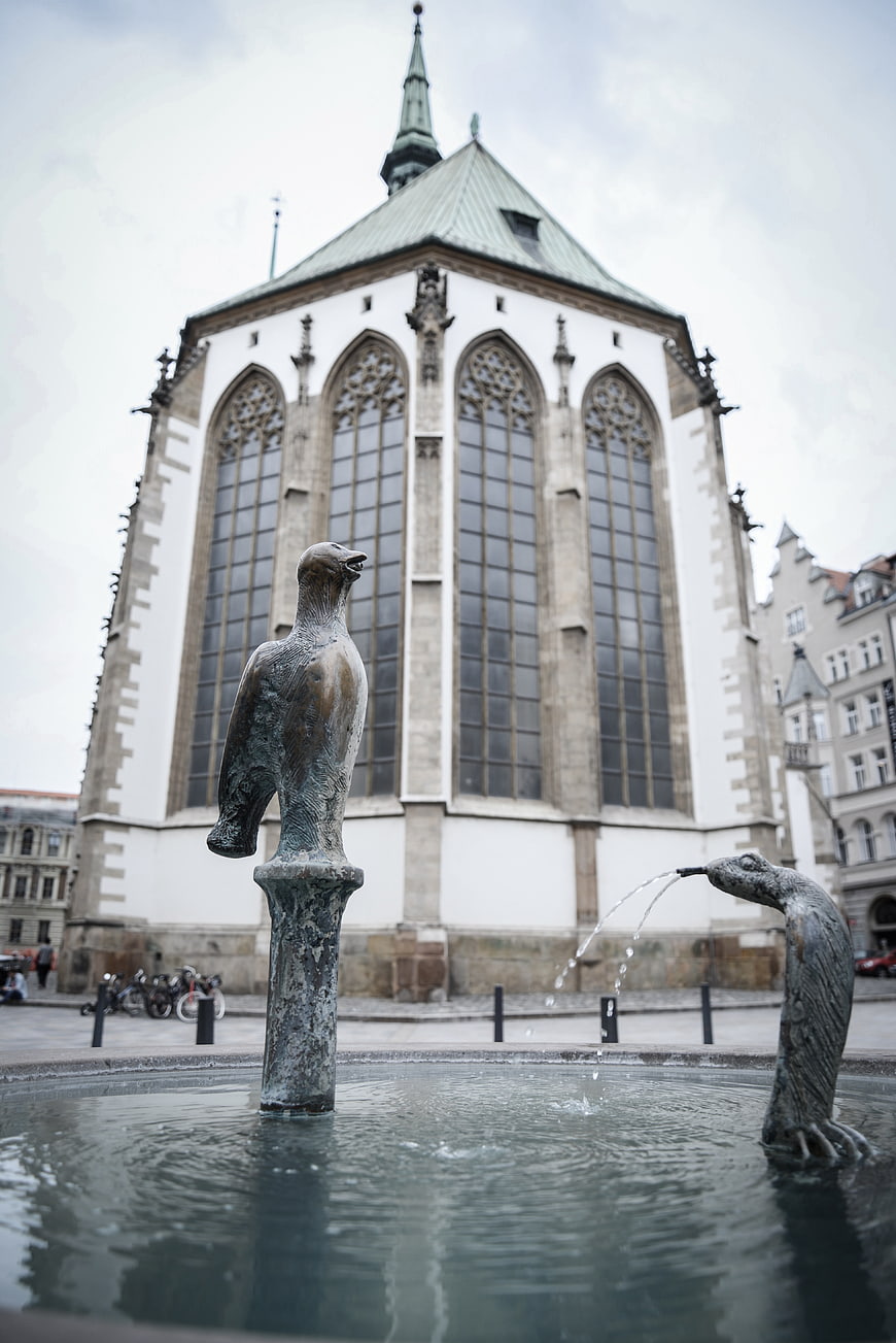 Bronze Bird Fountain in Front of Gothic Church