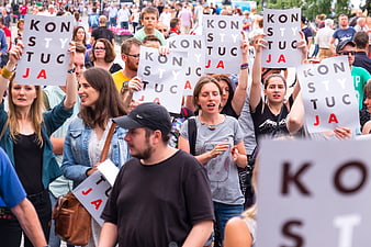 Crowd holding signs reading Konstytucja at a protest rally