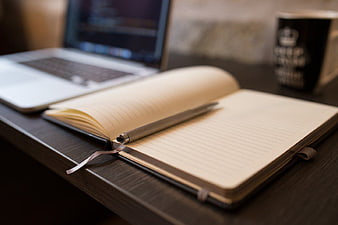 Open Notebook and Pen on Desk with Laptop and Coffee