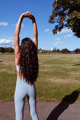 Woman Stretching Arms in Park