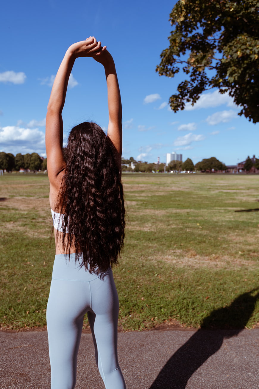 Woman Stretching Arms in Park
