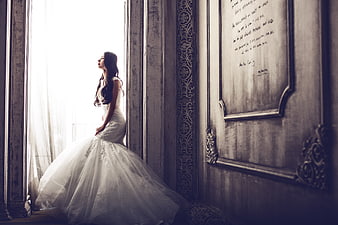 Elegant Bride in White Gown by Vintage Window