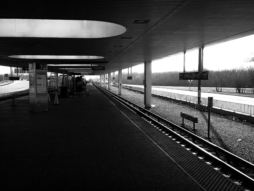 Black and white photo of empty train station platform