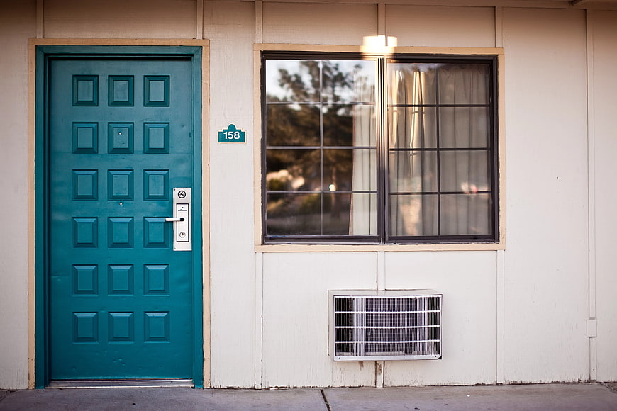 Teal Front Door and Window on Beige House Exterior