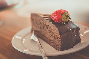 Slice of Chocolate Cake with Strawberry on White Plate