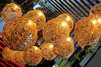 Cluster of glowing woven rattan sphere pendant lights