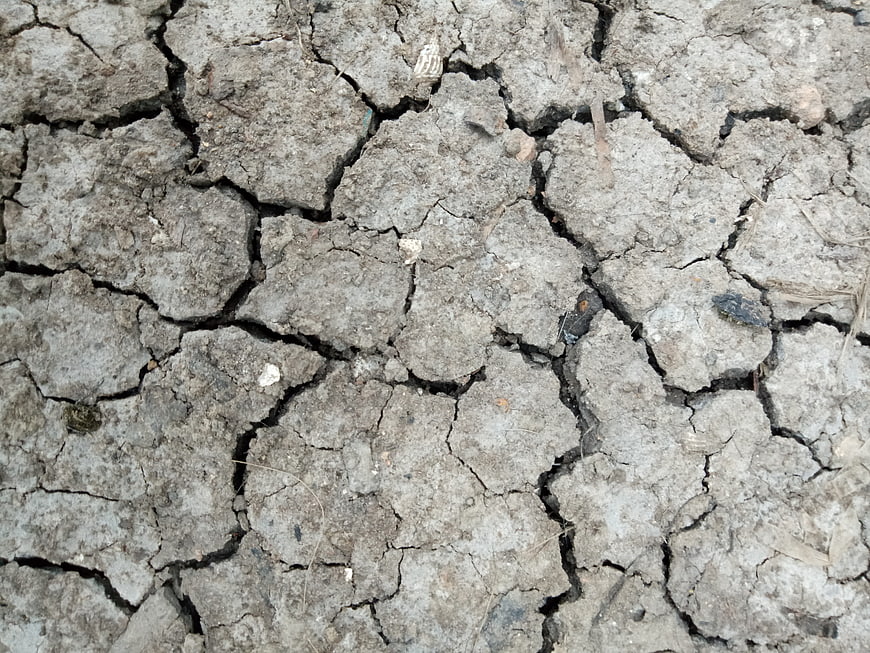 Close-up of cracked dry earth soil texture