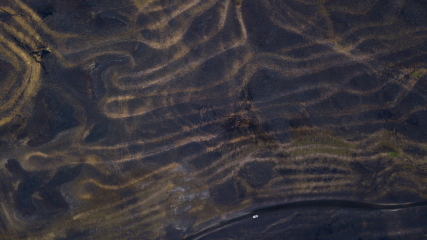 Aerial view of textured dark volcanic sand dunes in Iceland