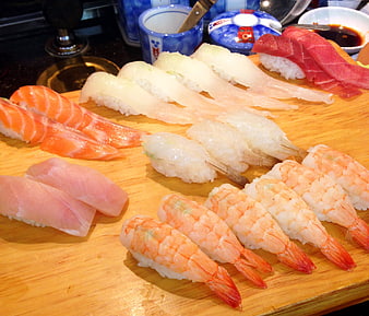 Assorted Fresh Sushi Platter With Salmon, Tuna, And Shrimp On Wooden Board