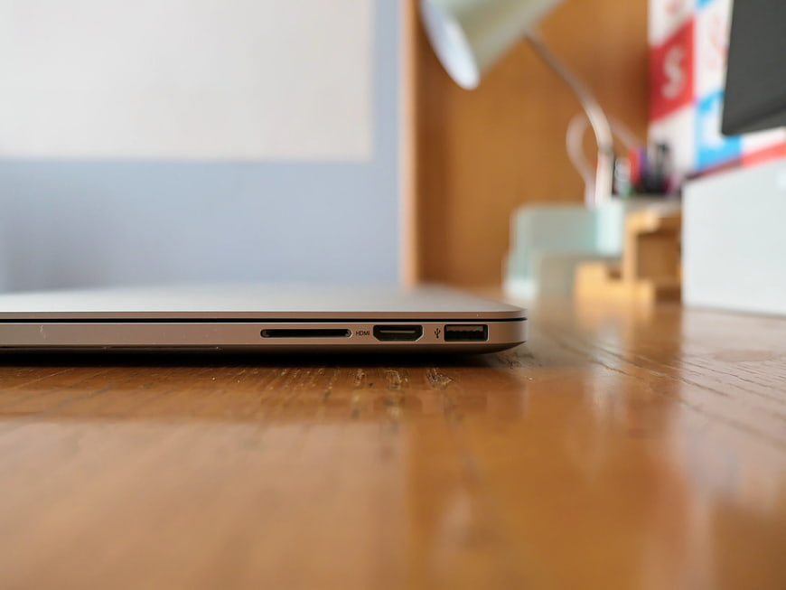 Close-up of laptop ports on wooden desk