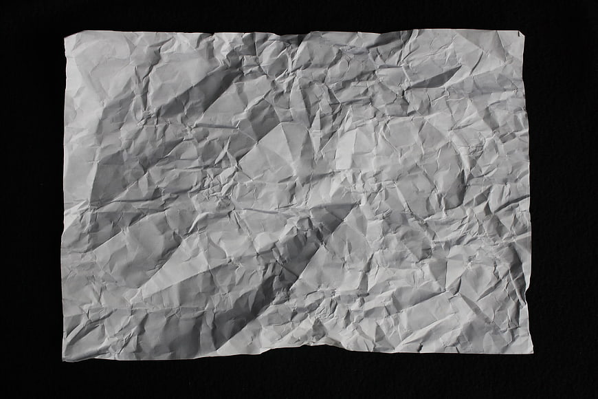Crumpled White Paper Texture On Black Background