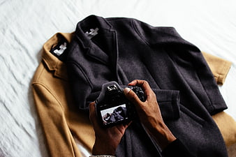 Photographer taking photo of jackets with DSLR camera