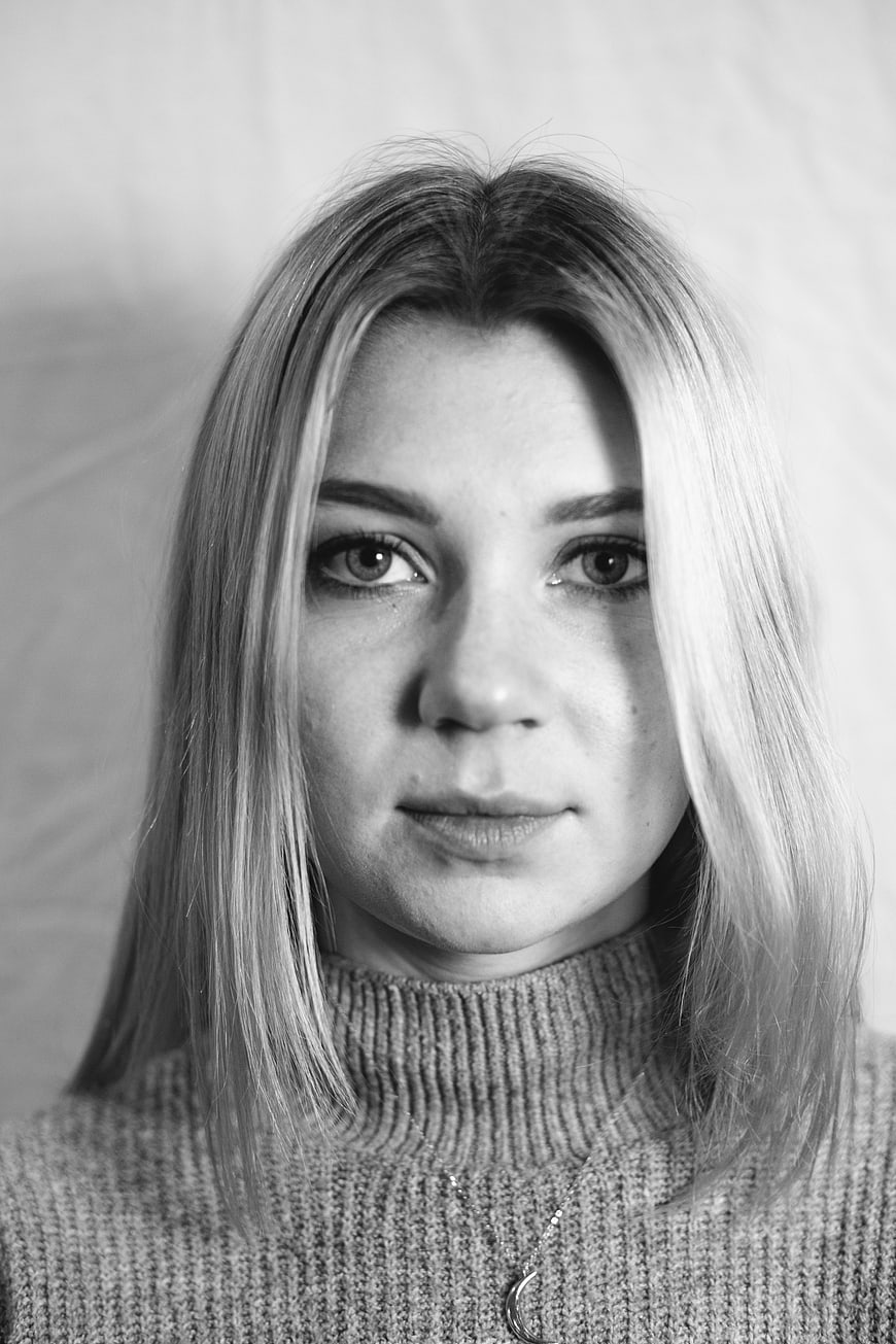 Black and white portrait of young woman in turtleneck