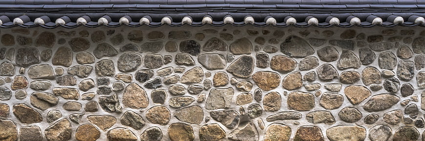 Traditional Stone Wall Texture With Dark Roof Tiles