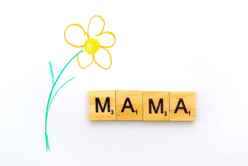 Mama Scrabble Tiles With Crayon Flower Drawing On White Background