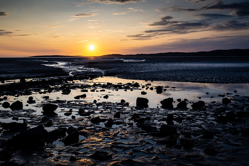 Dramatic Sunset Over Rocky Tide Pools and Coastal Mudflats