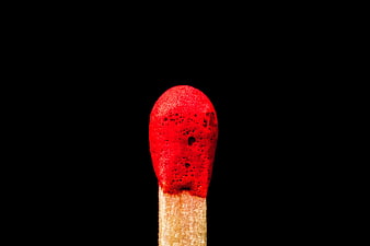 Close-up of red matchstick head on black background