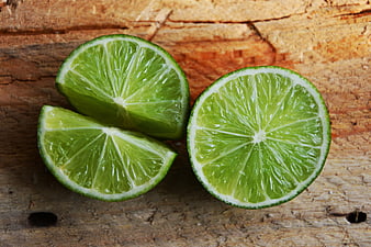 Fresh Cut Limes on Rustic Wooden Background