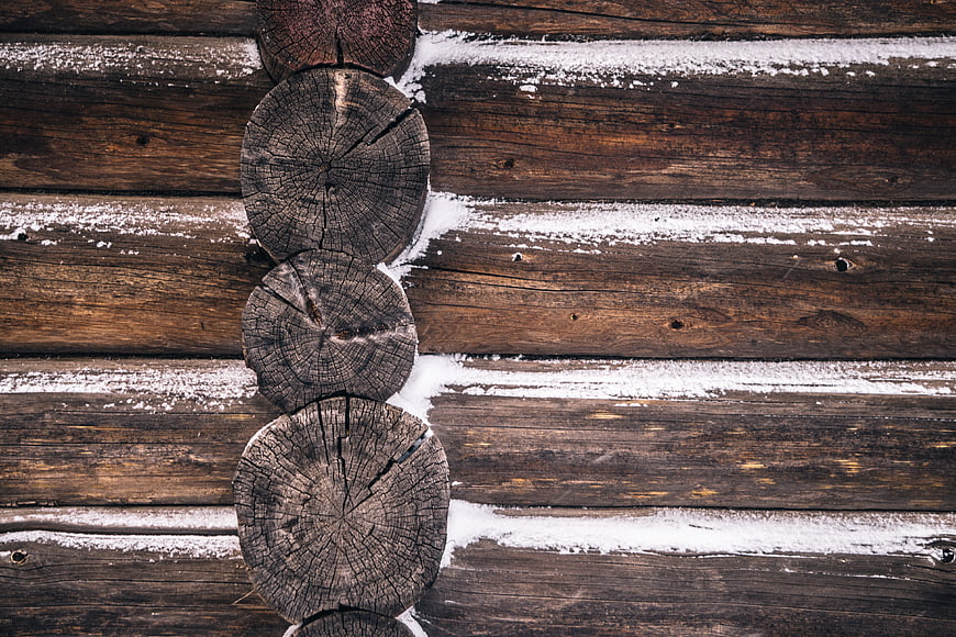 Snowy wooden log cabin wall texture background