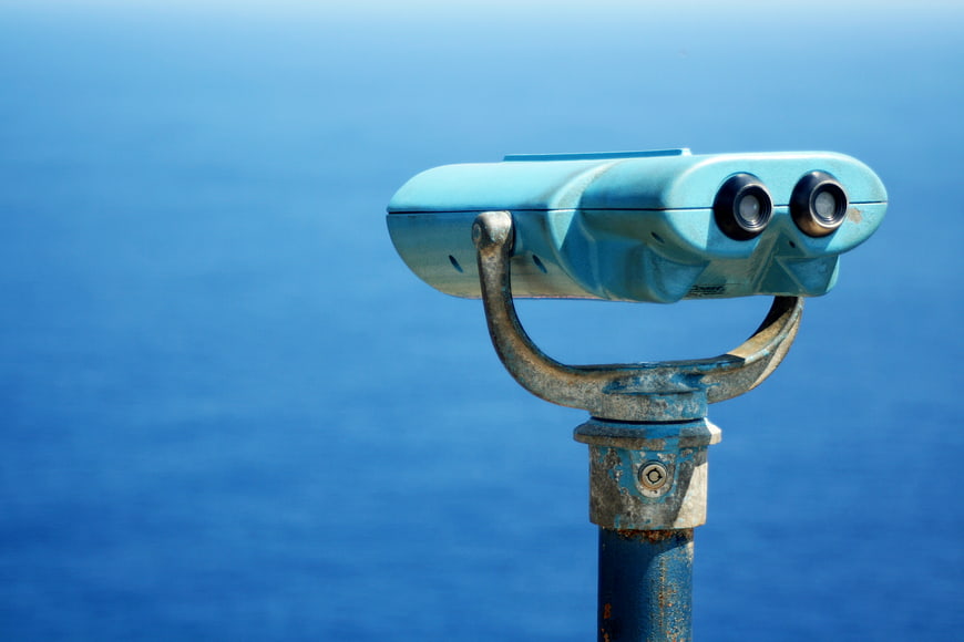 Blue Coin-Operated Binoculars Overlooking the Ocean