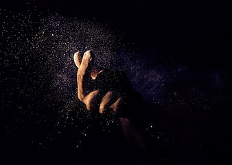 Hand Flicking Glittering Dust Particles in Dark Studio