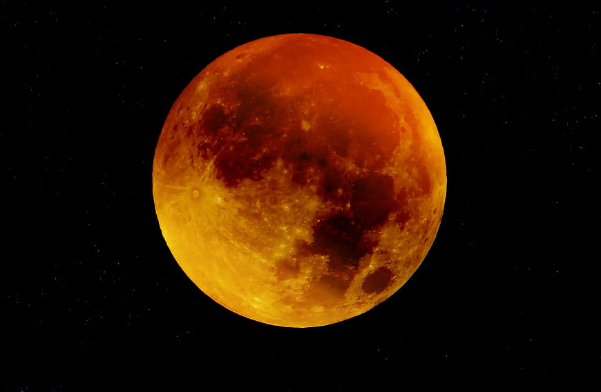 Vibrant Blood Moon with Craters Against Starry Night Sky