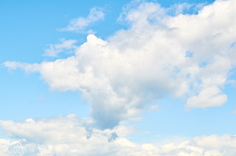 Fluffy White Clouds in Bright Blue Sky