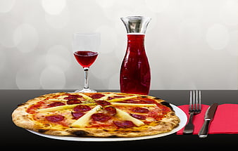 Italian Pizza with Red Wine and Carafe on Table