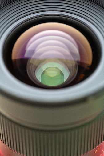 Close-up of camera lens glass with colorful reflections