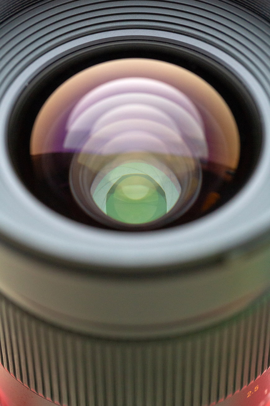 Close-up of camera lens glass with colorful reflections