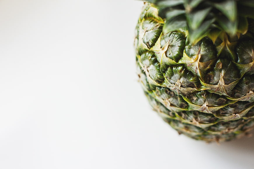 Close-up of green pineapple on white background