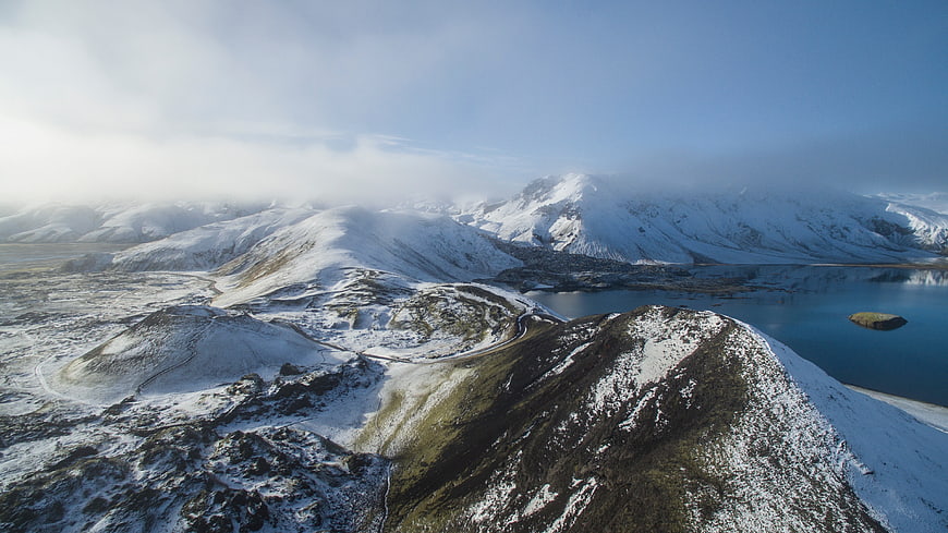 Aerial View of Snow-Covered Mountains and Lake
