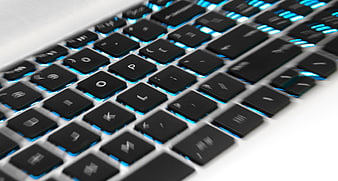 Close-up of laptop keyboard with blue backlighting
