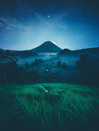 Volcanic Mountain Landscape Under Starry Night Sky With Crescent Moon