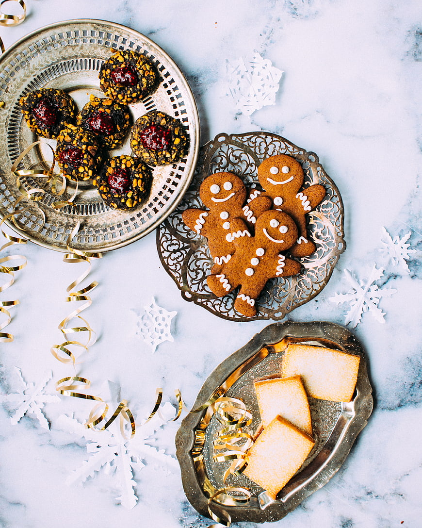 Flat lay of Christmas cookies on silver trays with snowflakes