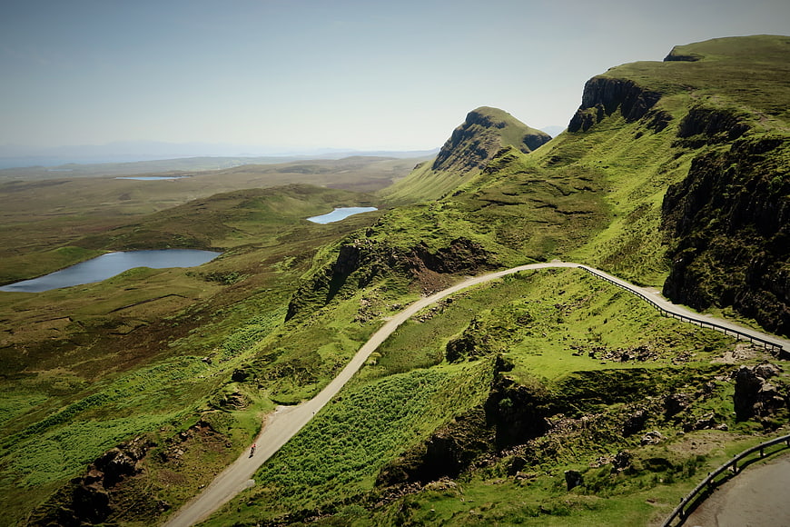 Winding Road Through Green Highland Mountains and Lakes