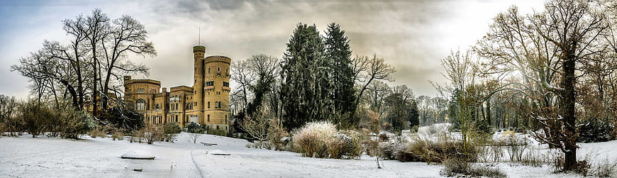 Panoramic view of Babelsberg Palace in snowy winter landscape