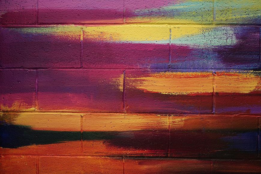 Colorful abstract graffiti art on textured brick wall background