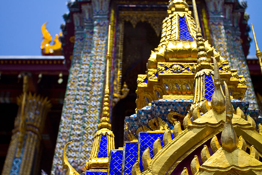 Golden Thai Temple Architecture with Blue Mosaic Details