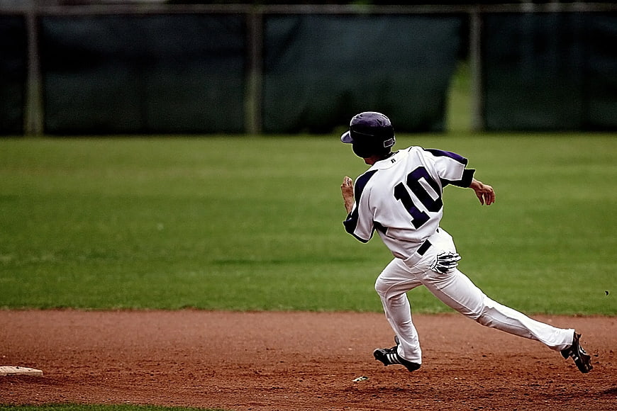 Baseball Player Running on Dirt Field