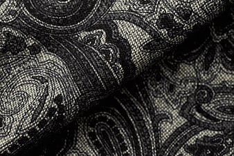 Close-up of black and gray paisley woven fabric texture