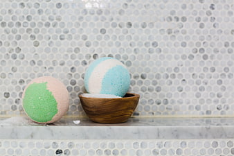 Pastel Bath Bombs on Marble Shelf with Wooden Bowl